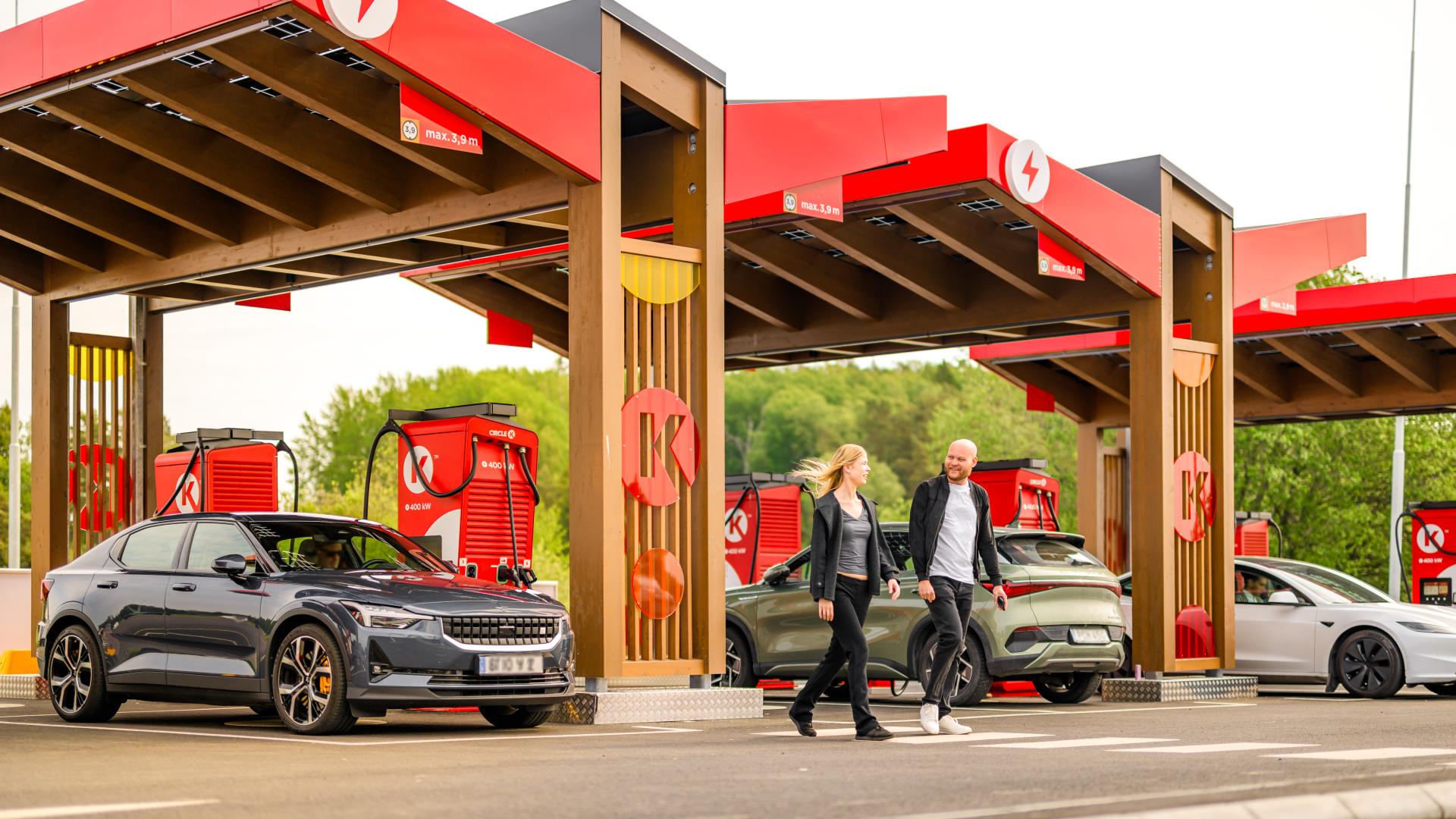picture of EV chargers and two customers